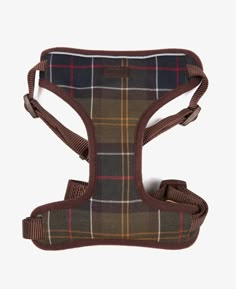 a brown plaid dog harness with no leash on the front and back, attached to it's chest