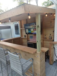 an outdoor bar with chairs around it