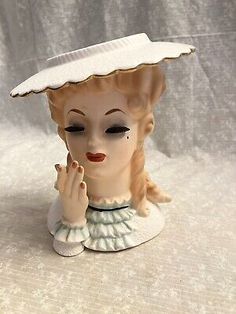 a ceramic figurine with a hat on it's head