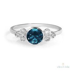 "14k London Blue Topaz Engagement Ring, Natural Blue Topaz Ring, Art Deco Topaz Diamond Cluster Wedding Ring, Women Anniversary Promise Ring ★ ★ ★ ★ CUSTOM/DUTY-FREE SHIPPING WORLDWIDE, BUYERS DON'T HAVE TO PAY ANY CUSTOM FEES WHILE IMPORTING ★ ★ ★ ★ Details Made to order Material: 14k/18k Gold Color Options: Yellow Gold, White Gold, Rose Gold ★ Center Stone London Blue Topaz, Round Size: 6 mm Approx Weight (Ct): 0.75 ★ Accent Stones Diamond Round Size: 1.8mm * 6 Nos Approx Weight (Ct): 0.15 ★ 1 Blue White Topaz Ring For Promise, Blue Topaz Ring With Bezel Setting For Promise, Blue Topaz Ring With Bezel Setting, Blue Topaz Ring With Round Cut Bezel Setting, Blue White Topaz Ring For Anniversary, Blue Birthstone Ring With Bezel Setting For Wedding, Anniversary Blue White Topaz Ring, Bezel Set Topaz Ring For Anniversary, Wedding Blue Topaz Ring With Bezel Setting