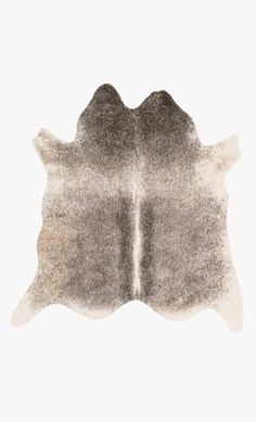 a cowhide rug is shown in grey and white colors on a gray background, with the top part of an animal's skin visible