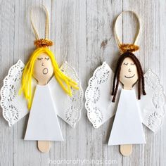 two paper angel ornaments with yellow hair and blonde hair, hanging on white doily