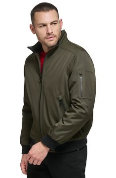 Every closet craves this edgy bomber styled with handy side pockets, a water-resistant finish and comfy ribbed trim. Front zip closure Stand collar Front zip pockets Ribbed cuffs and hem Water resistant Lined 100% polyester Machine wash, line dry Imported Nordstrom Store, Stand Collar, Nordstrom Rack, Zip Pockets, Calvin Klein, Bomber Jacket, Water Resistant, Nordstrom, Slim Fit