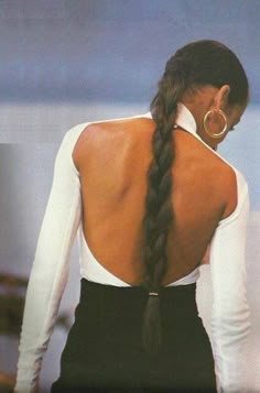 the back of a woman's dress with long braids