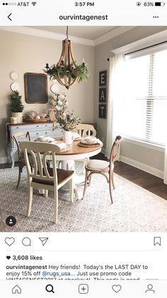 the dining room table is set for two with white dishes and place settings on it