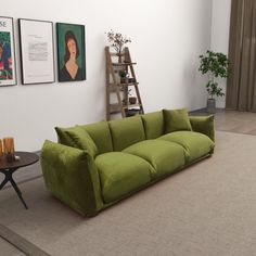 a green couch sitting in the middle of a living room