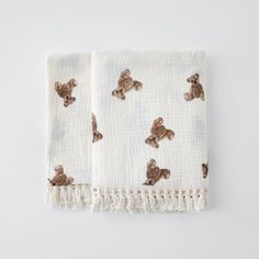 two white towels with brown teddy bears on them