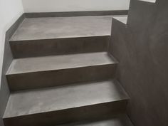 concrete steps leading up to a white wall