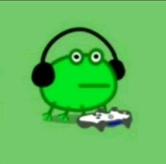 a green frog with headphones and a video game controller in front of it's face