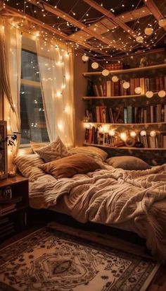 an unmade bed with lights strung from the ceiling and bookshelves above it