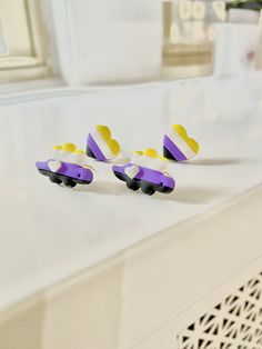 three toy cars sitting on top of a white counter