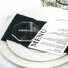 a white plate topped with black napkins and silverware