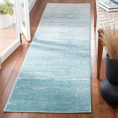 a blue runner rug on a wooden floor