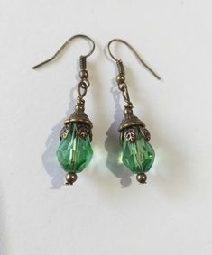 Emerald green Victorian bronze earrings Boho earrings Bronze earrings Bohemian earrings Vintage emerald green teardrop flower earrings gift boho earrings Edwardian earrings Gothic earrings Beautiful bronze Victorian style earrings with emerald green teardrop faceted glass beads. Antique style bronze tone Emerald green filigree earrings . Boho earrings. Bohemian earrings . Romantic style earrings. Baroque style earrings . Beautiful emerald-green earrings.  Perfect Gift for Her ! FREE SHIPPING  The Chain measures approximately 46 cm ( 18.20 inches). Material: bronze tone pendant, green teardrop faceted glass beads, bronze tone chain , bronze toned ornaments beads.  Length of necklace :  18.20 ( 46cm) Length of earrings with hooks - 1.7 (4.5 cm) If you have any question, please contact me ! T Green Drop Jewelry For Jewelry Making, Green Crystal Metal Earrings, Green Teardrop Earrings As Gift, Green Teardrop Earrings For Gift, Handmade Green Crystal Metal Earrings, Green Teardrop Drop Earrings For Jewelry Making, Nickel-free Green Drop Jewelry, Green Nickel-free Drop Jewelry, Green Teardrop May Birthstone Earrings