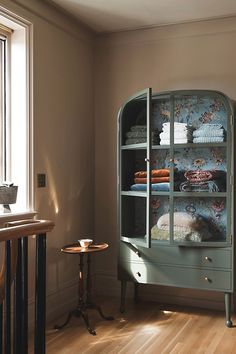 an old china cabinet in the corner of a room