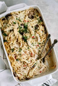 a casserole dish with pasta, mushrooms and parsley