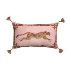 a pink pillow with a cheetah on the front and tasselled edges