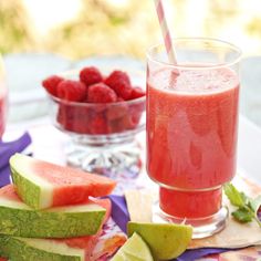 watermelon, raspberry and cucumber drink on a table with other fruit