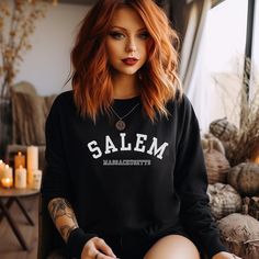 Embrace the magic of Salem with our cozy fall sweater! Wrap yourself in comfort and witchy vibes with this super soft sweater featuring the enchanting city of Salem, Massachusetts. Perfect for chilly autumn days, this sweater is made with the finest materials to keep you warm and stylish. Embrace the magic of Salem with our cozy fall sweater! Wrap yourself in comfort and witchy vibes with this super soft sweater featuring the enchanting city of Salem, Massachusetts. Perfect for chilly autumn day Outfits For Salem Massachusetts, Salem Massachusetts Fall, Witchy Vibes Outfit, Salem Outfits Fall, Witchy Long Sleeve Sweatshirt For Fall, Alternative Fall Fashion, Salem Shirt Ideas, Massachusetts Fall, Modern Witch Fashion