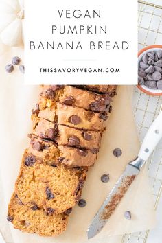 a loaf of vegan pumpkin banana bread on a cutting board with chocolate chips next to it