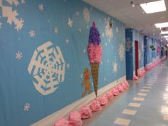 the hallway is decorated with pink pom poms and snowflakes on the wall