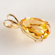 14k Yellow Gold Pear Citrine Solitaire Style Pendant 5.5ct 2.54g Metal Information: 14k Yellow Gold Total Weight: 2.54g Width: 10 MM Length: 23 MM Made By: Badavici Jewelry Stone Information Main StoneGem Type: Citrine Shape: Pear (15 x 10mm) Color: Orange Clarity/Quality: A Carat Weight: 5.5ct Number of Stones: 1 Total estimated ctw (carat total weight): 5.5ctw Estimated Retail Price: $1030.00 OUR PRICE: $825.00 44318 Luxury Citrine Pear-shaped Jewelry, Formal Gold Teardrop Gemstones, Gold Teardrop Gemstones For Formal Occasions, Gold Teardrop Gemstones For Formal Events, Yellow Gold Teardrop Gemstones For Anniversary, Anniversary Yellow Gold Teardrop Gemstones, Yellow Gold Pear-shaped Citrine Jewelry, Pear-shaped Citrine Jewelry In Yellow Gold, Yellow Gold Teardrop Gemstone