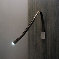 a door handle on a wooden door with light coming from the top and below it