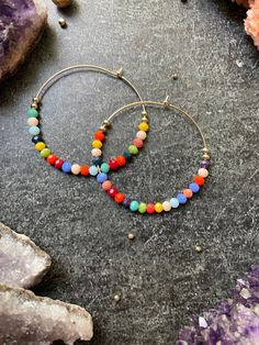 Colorful beaded hoops available on 14k gold filled or Sterling silver hoops. These measure approximately 1.75 inch in diameter. Who's ready for Vacay?!?  These are lovingly handcrafted and beaded with faceted 4 mm sparkling glass beads. Colorful Beaded Metal Hoop Earrings, Multicolor Dangling Beads Hoop Earrings, Rainbow Round Hoop Earrings With Colorful Beads, Rainbow Hoop Earrings With Colorful Beads, Adjustable Rainbow Hoop Earrings With Colorful Beads, Vacation Wear, Beaded Hoop Earrings, Beaded Hoops, Sterling Silver Hoops