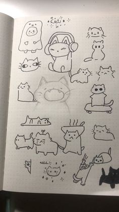 an open notebook with drawings of cats and dogs