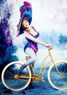 a painting of a woman riding a bike with an umbrella on it's head