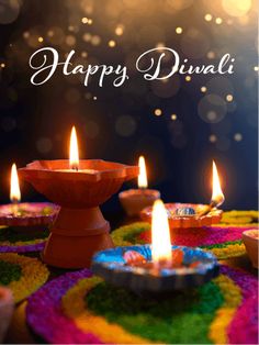 happy diwali greeting card with lit candles on colorful doily and boket background