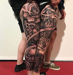 two people with black and white tattoos on their legs