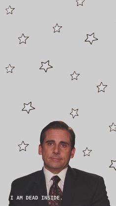 a man in a suit and tie is looking at the camera with stars above him