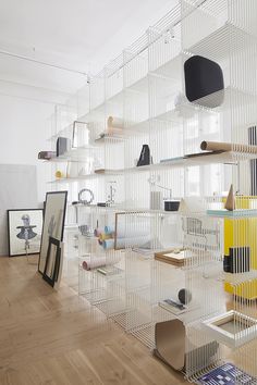 a room filled with lots of shelves covered in different types of objects and decor on top of hard wood flooring