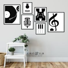 a white shelf sitting next to a wall filled with pictures and musical instruments on it