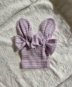 a pink and blue striped bow on top of a towel