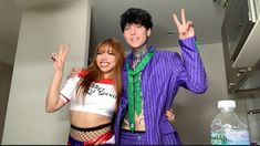 two people dressed up in costumes posing for a photo with one person making the peace sign