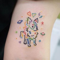 a small colorful tattoo on the back of a woman's left arm, with hearts and stars all over it