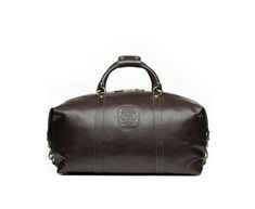 Since 1975, Ghurka has made iconic American goods for all our journeys, from the intercontinental to just across town. With each iconic design fit for purpose and imbued with functional luxury, the brand employs the finest leather craftsmanship to create classic, reliable pieces that only get better with age. A mid-size carry-on bag that’s perfect for short trips or as a personal item when flying, the Cavalier II No. 97 Duffel Bag in Vintage Tan Leather boasts an adjustable and detachable should Classic Leather-lined Travel Bag, Classic Leather Travel Bag, Classic Leather Lined Travel Bag, Classic Brown Travel Bag With Luggage Sleeve, Classic Travel Bag With Leather Lining, Classic Brown Luggage For Overnight Trips, Timeless Travel Bags With Leather Trim, Luxury Brown Weekender Bag For Business, Classic Brown Duffle Bag For Travel