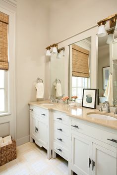 a large bathroom with two sinks and mirrors