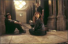 the harry potters are sitting on the floor in an old building with their feet up