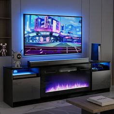 an entertainment center with a large television on it's side and blue lights in the back