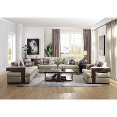 a living room filled with furniture and a large window covered in curtains next to a wooden floor