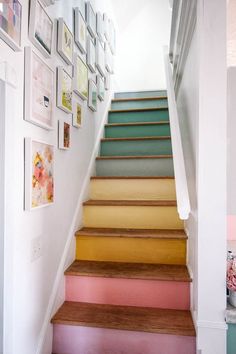 stairs painted in different colors with pictures on the wall