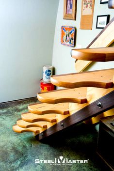 a wooden stair case sitting on top of a carpeted floor next to a wall