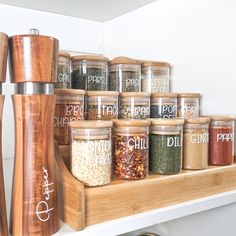 spice jars are lined up on a shelf