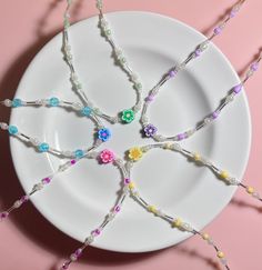 a white plate topped with lots of colorful beads