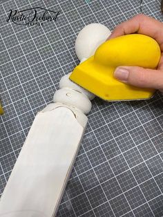 a person is using a yellow and white object to make something