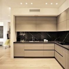 a kitchen with marble counter tops and white cabinets