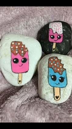 three rocks painted with ice cream and donuts on them